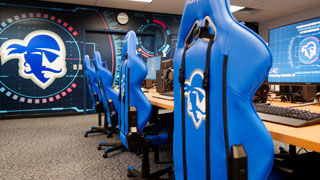 Seton Hall's Esports Lab with Pirate's log on chairs, wall and computers.