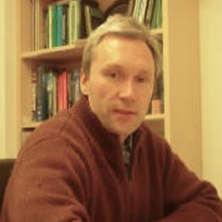 Faculty Headshot of Alexander Fadeev posing