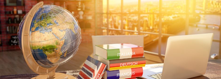 Image of a globe on a desk, with textbooks in English, French, Dutch, and Italian.