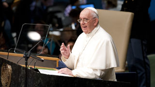 Pope Francis at a podium