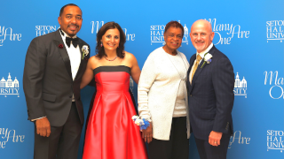 Interim President of the University, Dr. Katia Passerini, standing with this year's three honorees, Patrick Walsh '90 (2023), Dr. Sampson Davis '95 (2021), and Dr. Catherine Alicia Georges '65 (2020)