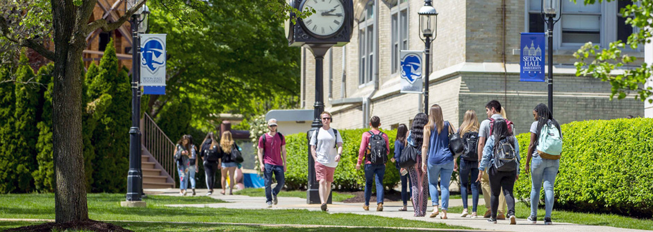 Students walking on path to class between Mooney and Stafford Hall