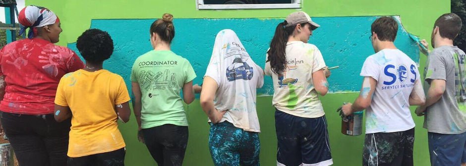 Students painting a house