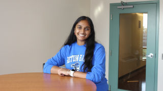 Rosmy Alengaden posing in a SHU building room