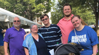 Daniel Devine standing with his whole family