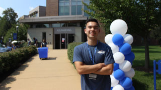 Ethan Brady standing in front of SHU campus building