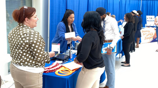 Recent SHU Graduates discuss with employers at career fair 