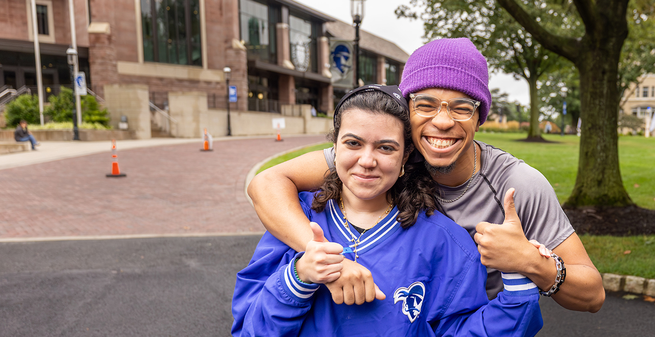 A photo of two students moving to campus.