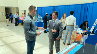 Student discusses employment opportunities with employer at the Career Fair. Student discusses employment opportunities with employer at the Career Fair.