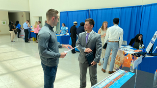 Recent SHU Graduates discuss with employers at career fair Student discusses employment opportunities with employer at the Career Fair. 