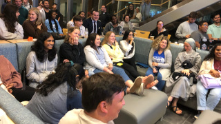 a picture of a group of students sitting together chatting