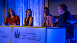 a photo of Seton Hall students at the Galaa photo of a panel discussion