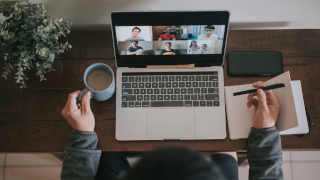 People wearing masks in a waiting room for job interview. laptop with video call and coffee