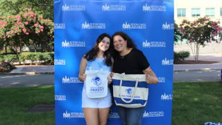 Taylor Castaldo standing with her mother with SHU background
