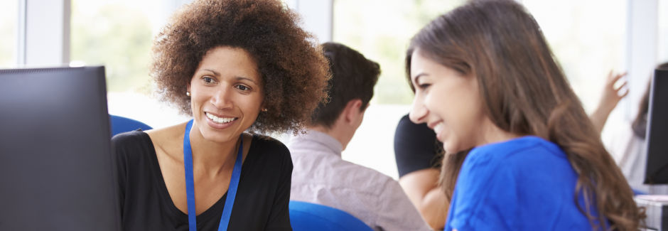 A photo of a student talking with an adviser.