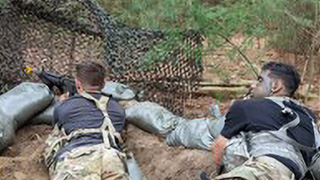 Underclass cadets as OPFOR use sandbags for defensive positions.