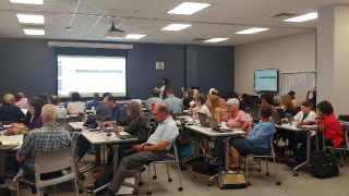 faculty members participating in an in-person workshop with computers