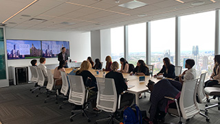 Photo of students learning about Sloane &amp; Company, a New York-based PR firm, at a Career Center site visit presentation by employees.