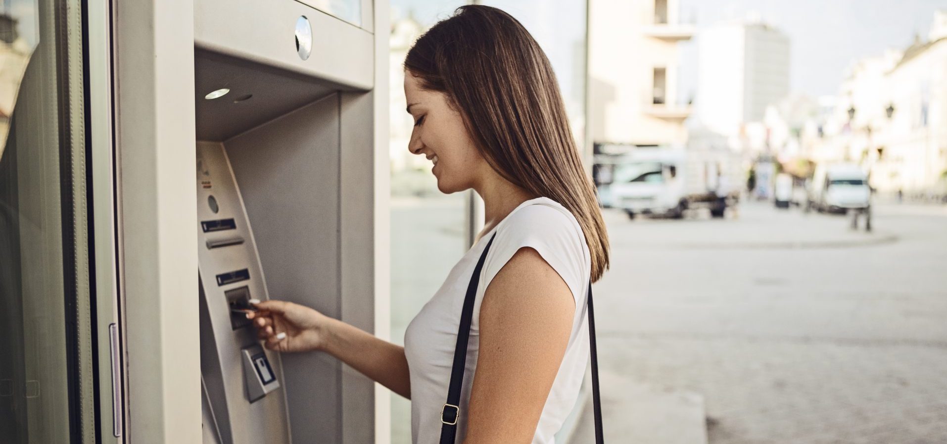 A student taking out money at an international ATM