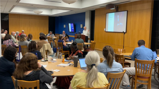 Faculty members listening to a presentation during the 2023 Summer Seminar.