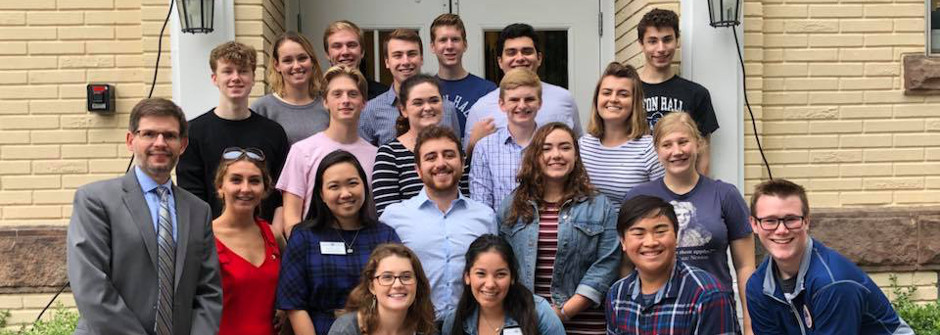 Courtney Smith and students standing on stairs. 