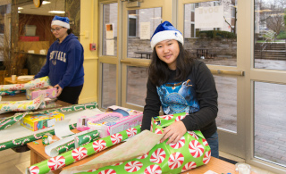 Young female wrapping a gift