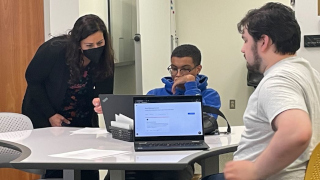 A photo of students attending a workshopA photo of students with laptops