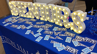 Photo of the Pirate posing with seniors at the annual Last 56 Days event.Photo of the decorated Seniors table at the annual Last 56 Days event.