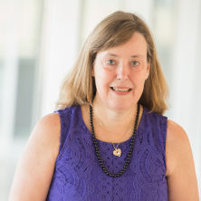 Diane McClure smiling in purple shirt