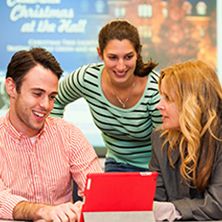 2 students and a professor utilizing an iPad to learn x222