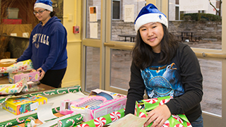 Young female wrapping a gift