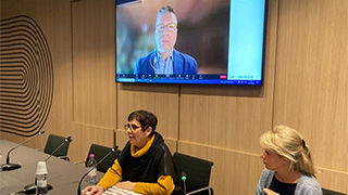 Photo of Professor Christopher Tienken presenting at an international conference on neoliberalism in education.