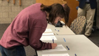 Girl writing on a paper