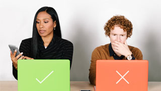 Man and Woman sitting in front of laptop