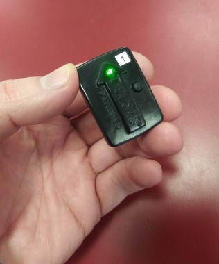 Photo of a hand holding an EMG sensor.