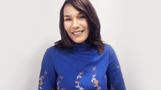 Earlene Cruz in blue blouse, headshot