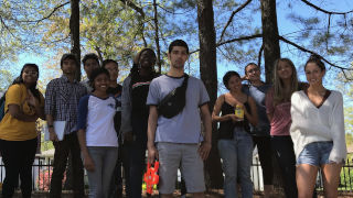 Environmental Studies students standing beside trees