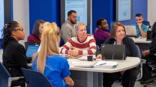 Faculty in a workshop with computers.