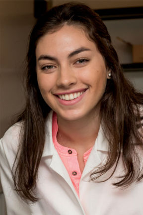 Female student in pink shirt and white coat