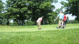 men golfing outside