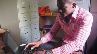 Man with Hands Up For Haiti laptop 