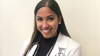 Jasmine Ahmed in labcoat, smiling