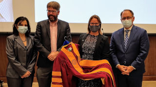 Jessica Cottrell standing with President Nyre and other faculty members