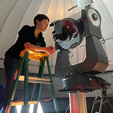 Katherine Moss on a ladder during the filming of the Seton Hal commerical.