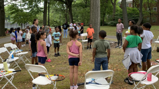 Newark Tennis School Players Students in the program gather for instruction.
