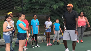 Retired tennis pro and GNTE Tennis Director Bob Bynum with the players during the summer session. 