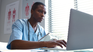 Male student working on a laptop