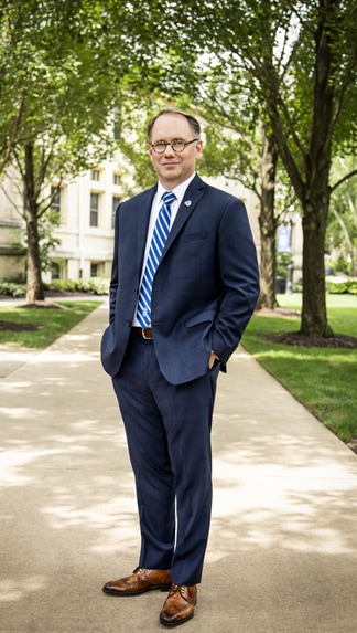 Joseph E. Nyre, Ph.D. in front of Bayley Hall