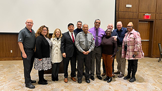 KNOW MORE Peer Educator Elyse Lanterman, a senior majoring in psychology, speaks with Officer Mo.Tom Krieglstein of Swift Kick stands next to Officer Mo.Officer Morrison and a group gather at Student Services' February Divisional Professional Development meeting. 