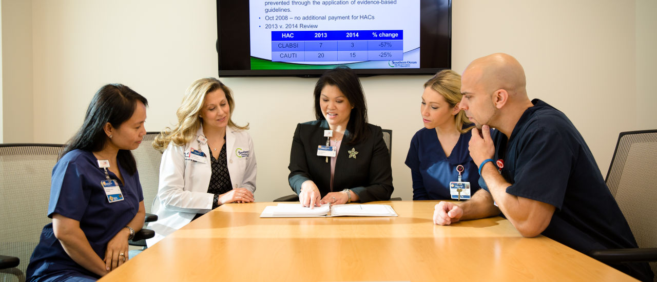 Health administrators at a conference table. 